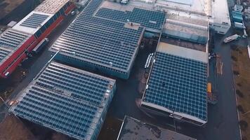 Sunny batteries on the roofs of industrial buildings. View from the air on a modern solar farm. Green alternative source of energy. Aerial view. video