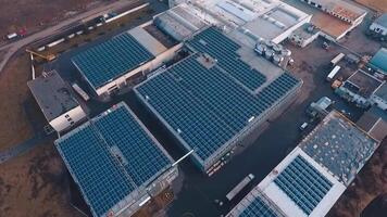 Huge solar farm on rooftop of buildings. Photovoltaic solar panels receive ecological energy from the sunlight. Aerial view. video