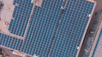 Many solar panels mounted of industrial building roof. Building with solar panels on roof with renewable energy from the sun. Aerial view. Camera rising up. video