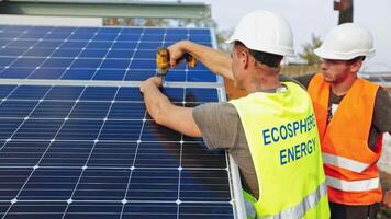 Workers installing photovoltaic solar panels. Men in white helmets installing sunny batteries. Renewable source of energy. video