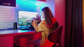 Nervous woman playing a game. Girl sitting in front of the computer and playing with disappointment. Racing with a steering wheel at home. Gaming at home. video