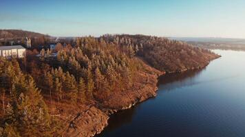 Beautiful lake near the forest. Calm evening in nature. River and trees landscape in winter without snow. Motion camera forward down. video