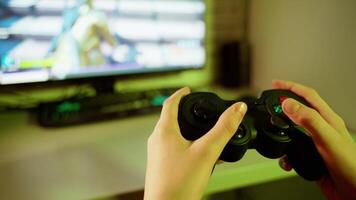Boy uses joystick to play game on Play Station. The console in gamer's hands during game time in front of the screen. Close-up. video