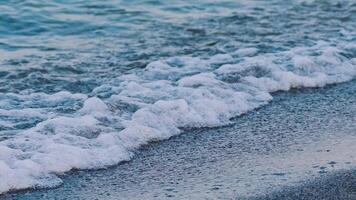 Sea waves on the seashore. Amazing view of the sea water. Waves crash on the pebble beach making white foam. Slow motion. video