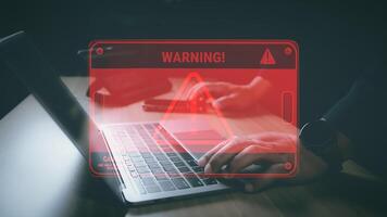 Hacker or programmer using laptop with triangle caution warning sign, coding, cryptography, hacker, crime, virus, for notification error and maintenance concept. Computer with red warning sign. photo