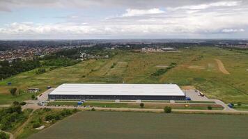 Contemporary business building. View from above on a modern industrial building surrounded by natural fields. Aerial view. Motion camera forward. video
