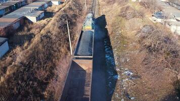 Freight train moving in winter. Top view on a cargo train on rails. Freight transport, railroad and transportation concept. Aerial view. video