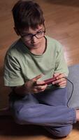 vertical Boy playing with a retro game console at home video