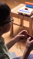vertical Child playing with retro game console at home video