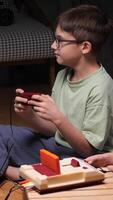 vertical Two kids playing with a retro game console at home video