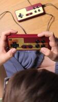 vertical Child playing with retro game console at home video
