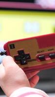 vertical Boy playing retro games holding joystick controller at home video
