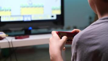 Boy playing retro games at home using controller video