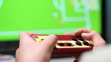 Child playing retro games using controller and television video