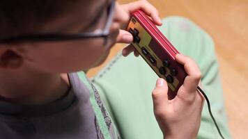 Child playing retro games with wired controller video