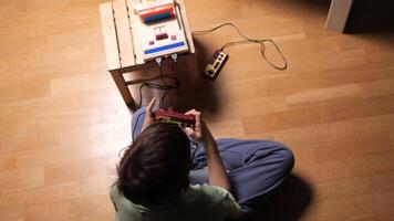 Child playing with retro game console at home video