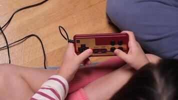 Child playing retro games using controller at home video
