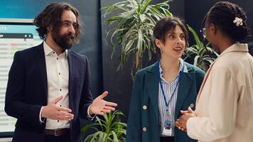 Staff members from a business organization are discussing interest in new projects during a corporate briefing meeting. Team of coworkers stays informed about industry developments. Camera A. photo
