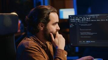 Computer scientist drinking cup of coffee while developing code on PC using java programming languages. IT admin brainstorming ways of fixing database errors, enjoying hot beverage, camera A photo