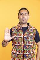Man trying to stop chaotic fight using calming hand gesture to diffuse tensions, doing peaceful resolution. Reassuring person doing calm down sign gesturing, studio background photo