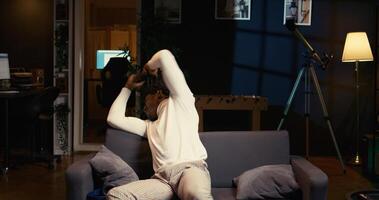 Annoyed gamer raging in frustration after losing mission while playing videogame on gaming console, ready to throw controller. African american man furiously yelling after failing to win level photo