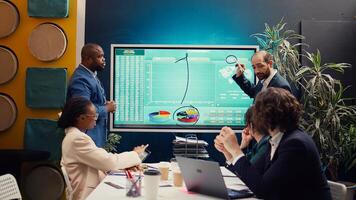 Account executive team analyzing trends to help in making important decisions to corelate with company objectives. Business associates working together to meet project deadline. Camera B. photo