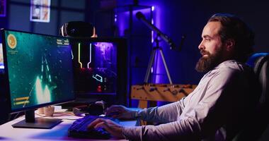 Man using gaming keyboard to fly spaceship in SF videogame. Gamer using powerful PC and computer peripherals to compete in online science fiction multiplayer game competition photo