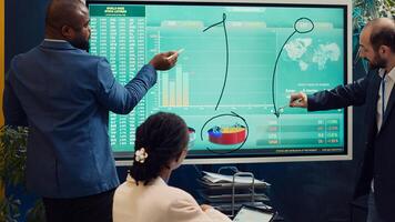 Account executive team analyzing trends to help in making important decisions to corelate with company objectives. Business associates working together to meet project deadline. Camera A. photo