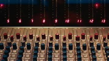 Empty professional studio with control desk mixer and pre amp knobs, music recording and editing with audio software. Control room buttons and sliders in post production, soundproof space. photo