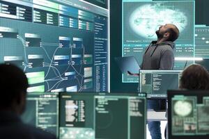 Hacker specialist working on governmental cyber surveillance in agency center, examining stolen information on a big screen during hybrid war. IT expert works on intelligence espionage. photo