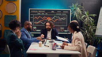 Coworkers addressing innovation initiatives in research and development efforts, making new plans and strategies to ensure goals accomplishment within the firm. Market supply and demands. Camera B. photo
