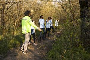 As the mission for the missing person grows worse, supervisor of the rescue operation team leads his crew into the woods in search of evidence. People shouting for the lost civilians name. photo