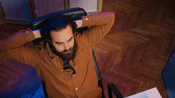 Outraged software engineer perplexed by impossible to remove bugs appearing while coding on computer desktop. Teleworking IT admin feeling baffled by script errors, putting hands on head, camera B photo