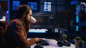 Stressed engineer feeling pressed by deadline, thinking how to finish developing code on PC. IT specialist brainstorming ways of solving database errors, working hard, drinking coffee, camera B photo