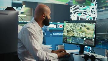 Middle eastern employee monitoring delivery truck gps coordinates to ensure fast shipment in control center. Shipping agency worker uses satellite map and radar surveillance footage. Camera B. photo