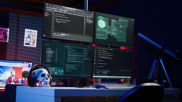 Close up shot of software interface on computer screens showing developer code running in empty criminals den. Hacking malware programming script on monitors in underground base photo
