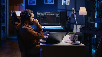Frenzied programmer suffering from adhd illness, impatiently taping desk with fingers while writing code. Jittery IT expert doing multitasking in office, drinking coffee, listening music, camera B photo
