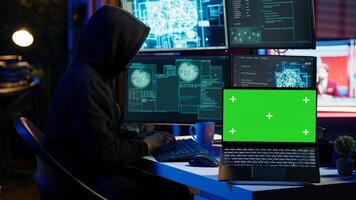 Isolated screen laptop used by cybercriminal in underground hideout to write lines of code and malware scripts. Mockup notebook used by evil programmer in hidden bunker, close up shot, camera A photo