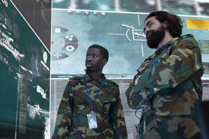 Diverse team of infantry unit soldiers analyzing crucial real time data on a big screen, gather intelligence to support troopers during field operations. Reconnaissance specialists work on espionage. photo