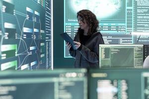 Cyber security expert investigates governmental hacking malware attack on big screen, high tech center. Cybercriminal woman hacks computer systems, threatening database protection. photo