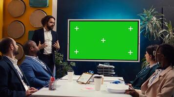 Startup team using greenscreen interactive board in a strategy workshop meeting, working together to improve their skills and performance. Corporation employees prepare for collaboration. Camera B. photo