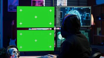 Cybercriminal using AI deep learning to produce virus corrupting data on mockup PC. Rogue developer working on isolated screen computer using artificial intelligence, penetrating security, camera A photo