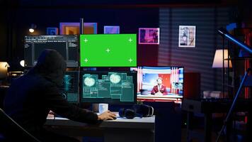 Cybercriminal hacking using green screen PC and getting critical error while trying to steal credit card information. Hacker runs code on mockup computer display, failing to breach firewall, camera B photo