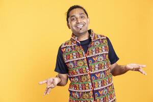 Portrait of cheerful man feeling amused by his lack of knowledge, shrugging shoulders. Jolly person doing questioning hand gesture, feeling entertained by indetermination, studio backdrop photo
