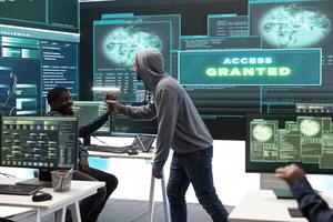 Pleased proud hackers team jumping around after gaining access into rival government database, feeling happy about their success. Professional IT experts hacking network systems. photo