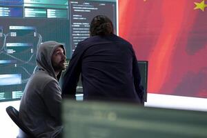 Chinese hacker uses computers in governmental cyber operations office to work on hybrid warfare and political manipulation. Inflicting manipulation and propaganda for the communism ideology. photo