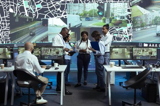 Diverse group of agency employees studying order logistics in control center, monitoring the delivery trucks activity via satellite navigation. Operators working with gps coordinates for tracking. photo