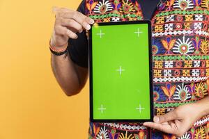Close up shot of influencer presenting isolated screen tablet for tech enthusiasts, studio backdrop. Focus on chroma key device displayed by technology professional used for advertising brands photo