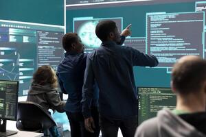 Governmental hacking team launches phishing attack to steal passwords and personal data for cyberwarfare tactics. Group of IT experts working to penetrate a database in monitoring room. photo