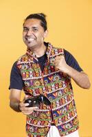 Joyous gamer celebrating achievement after winning game on gaming console, having fun. Ecstatic man feeling excited after being victorious in videogame using joypad, defeating all enemies photo